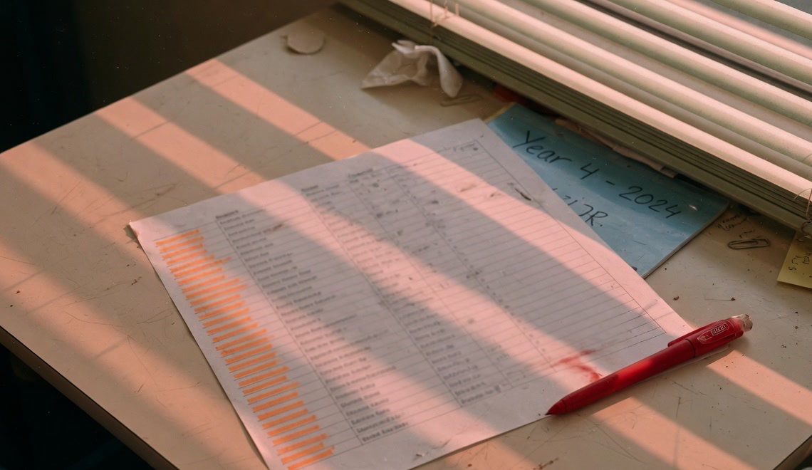 A marked class roll on a teacher's desk.